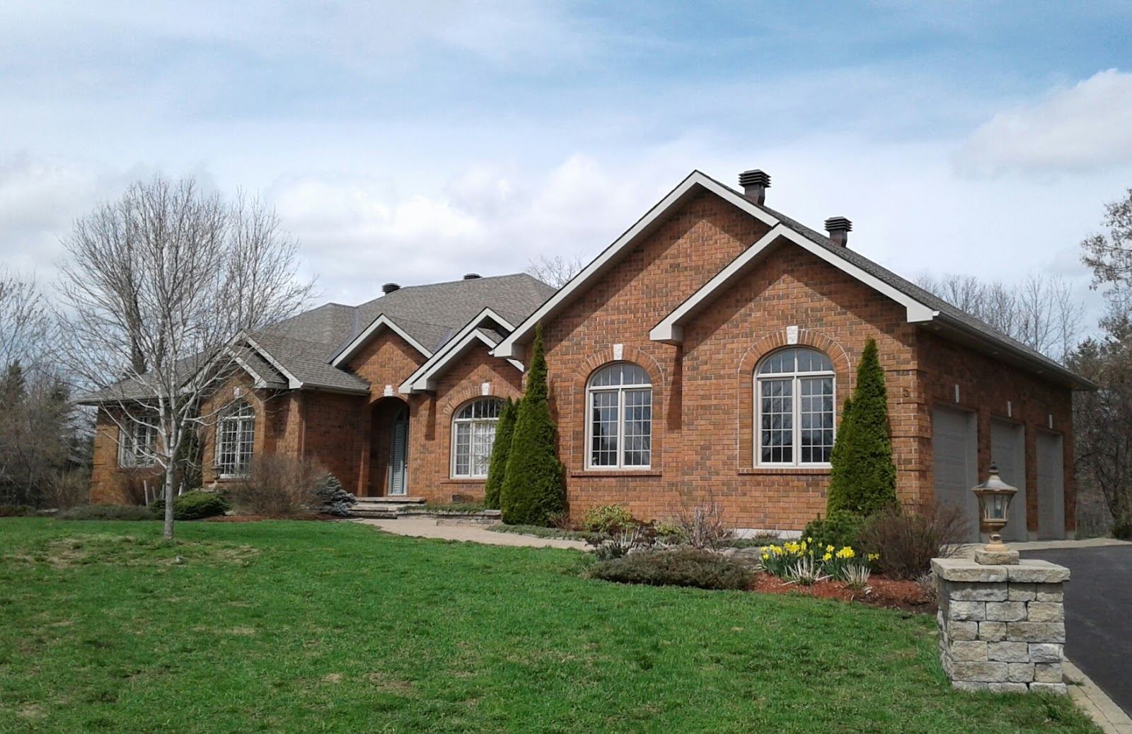 A red brick bungalow with a new shingle roof